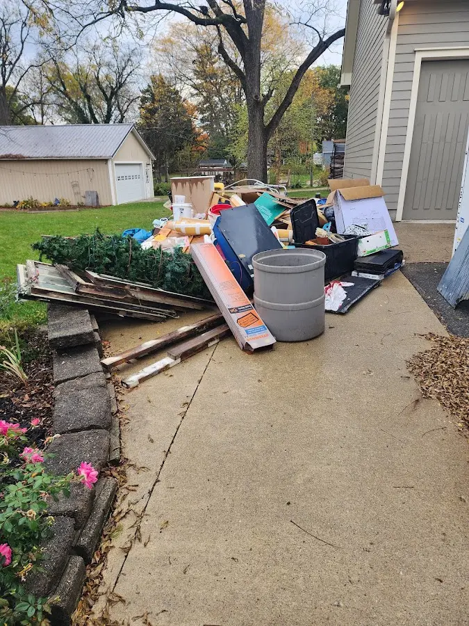 Dumpster being loaded with debris for Estate Cleanout Dumpster Rental in Tusculum